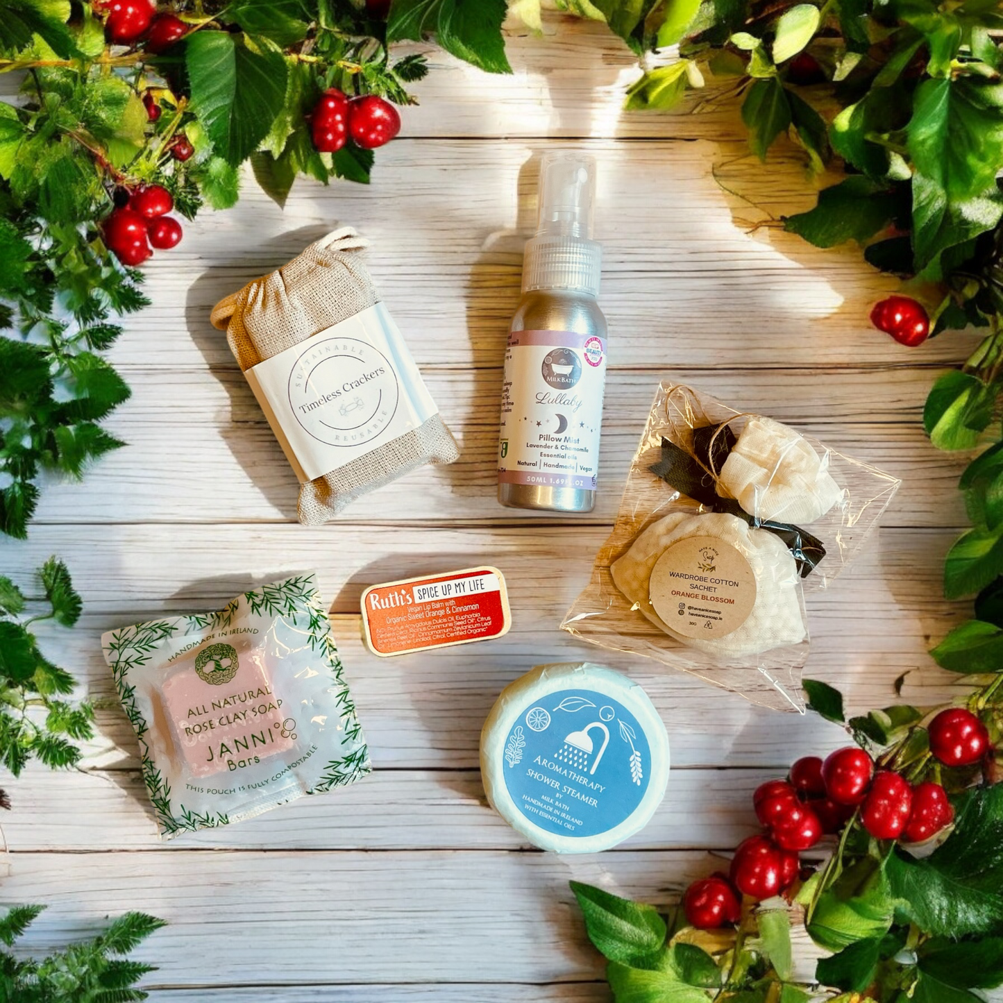 “Selection of cracker filler gifts including natural soap, lip balm, linen sachet, and room spray, all made in ireland, displayed with festive greenery all made in Ireland”