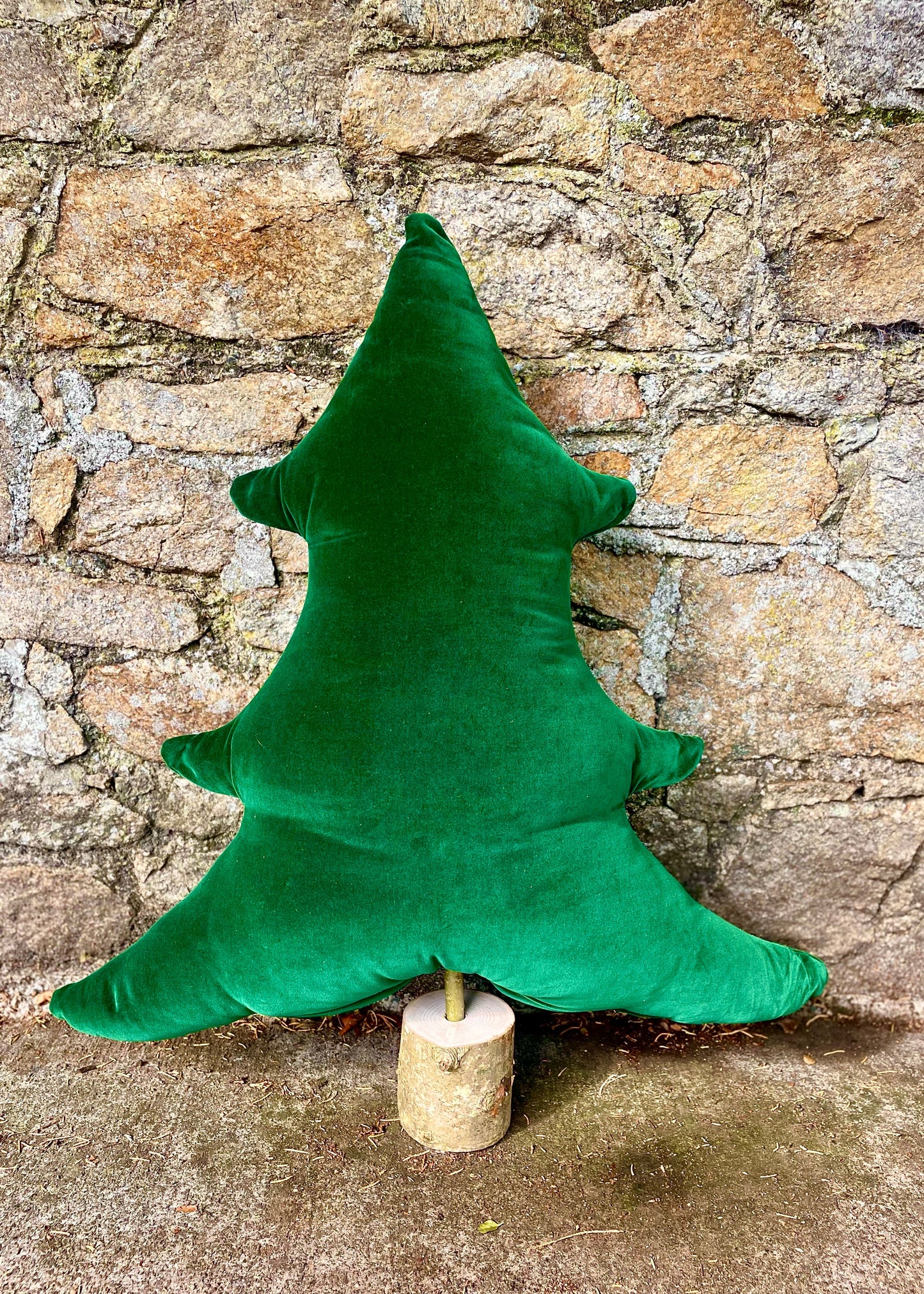 Green tree-shaped pillow on stand