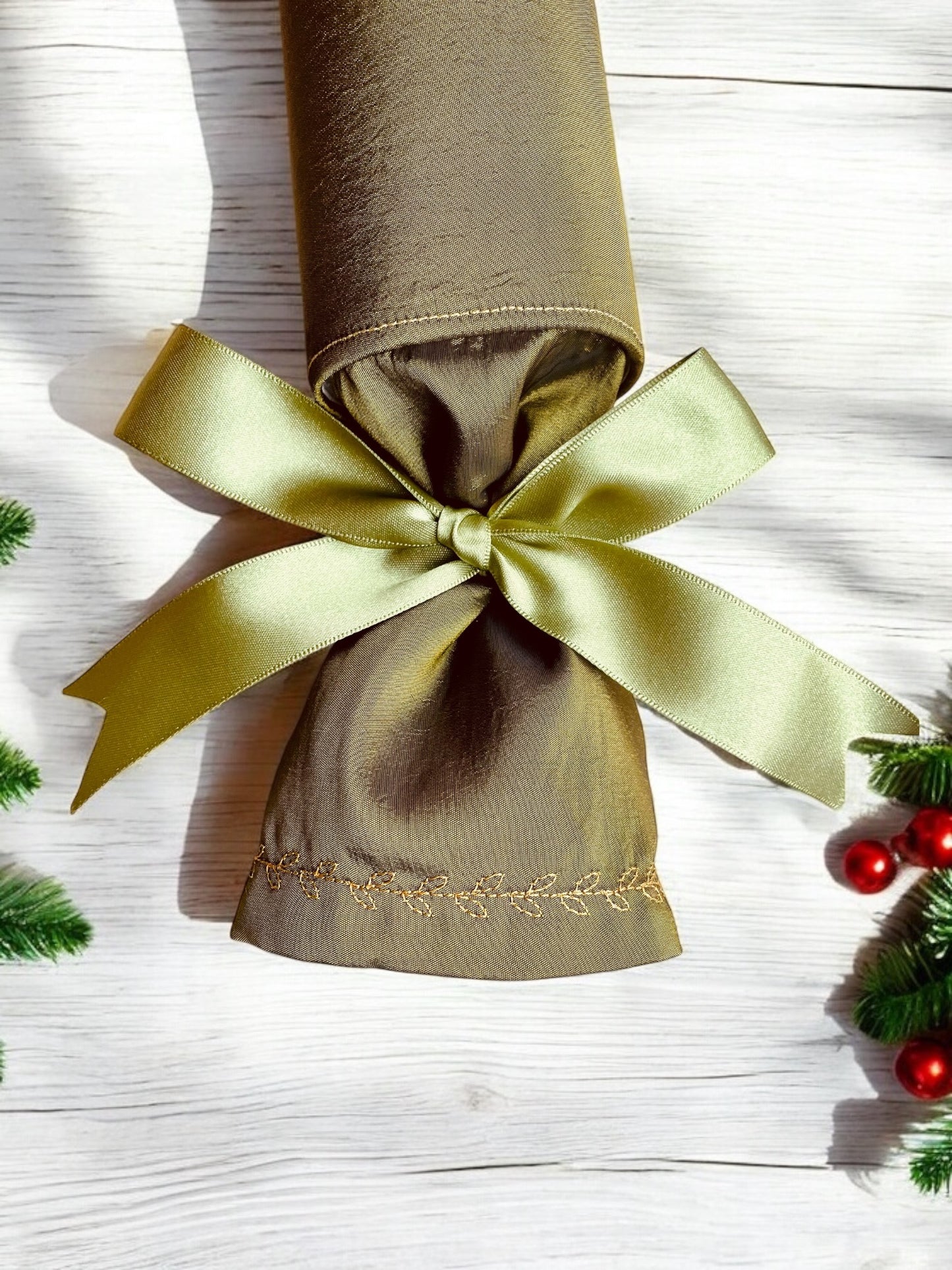 “Single Olive green reusable Christmas cracker with olive green ribbon and gold embroidery detail”