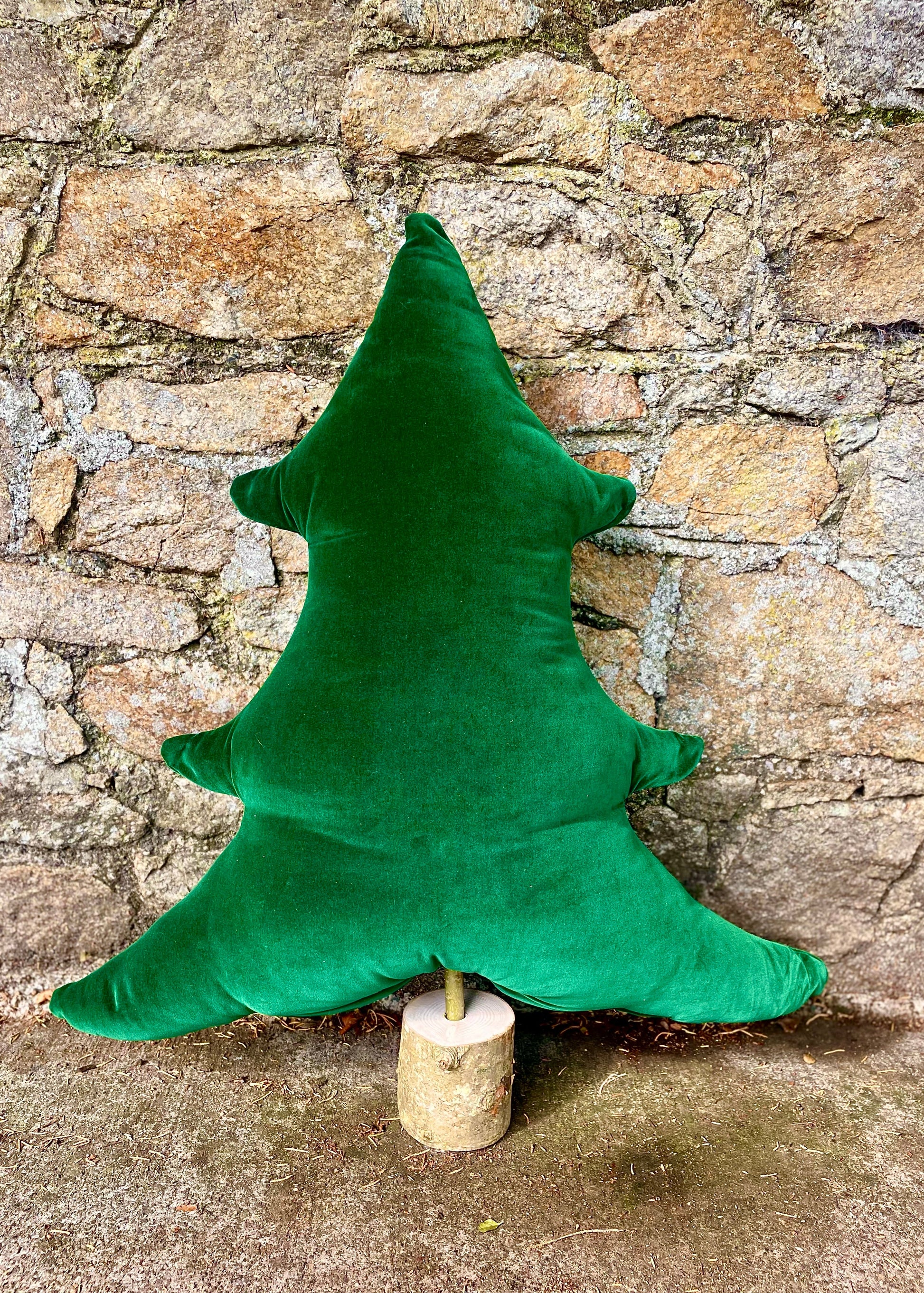 Green tree-shaped pillow on stand 