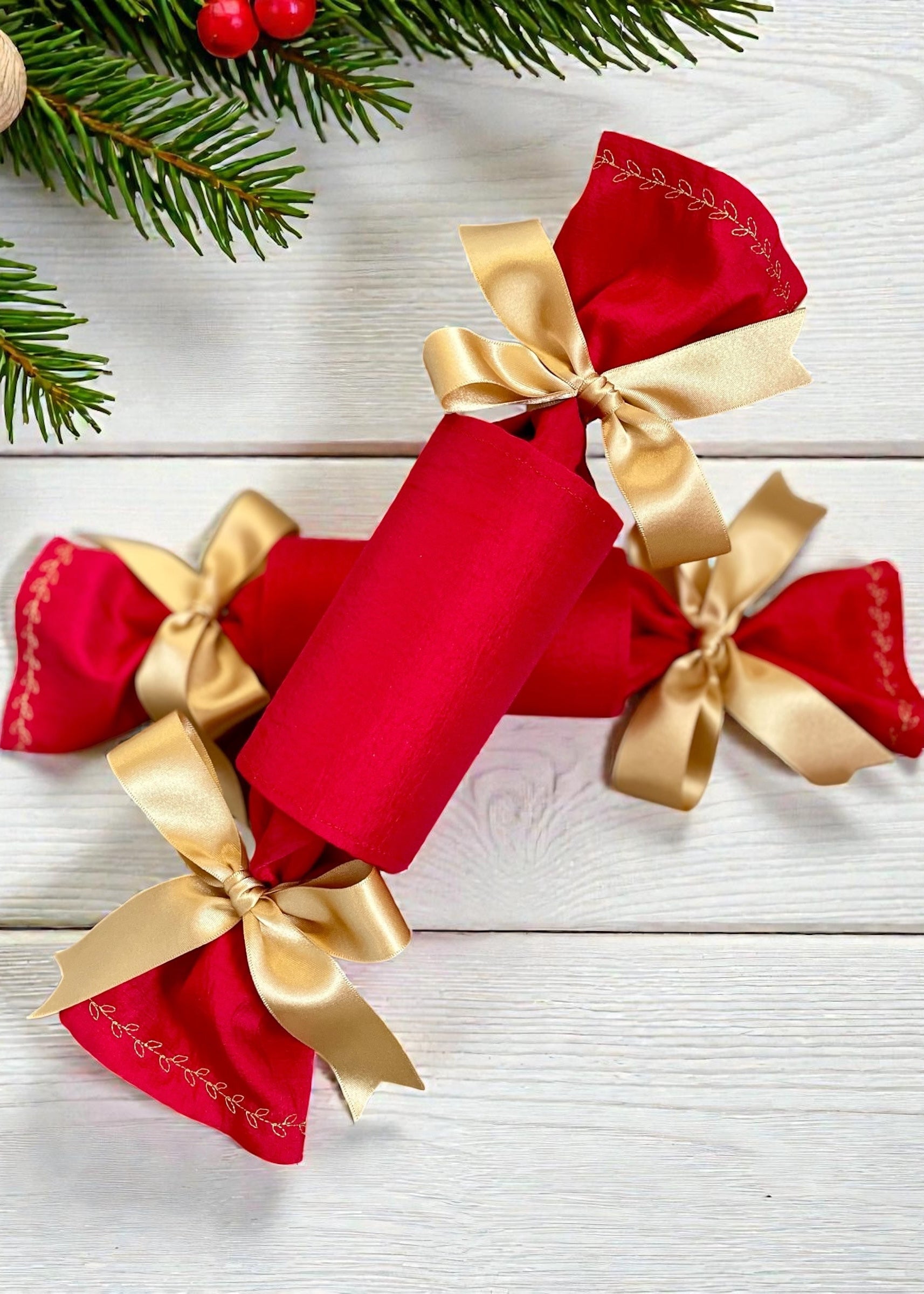 Reusable and refillable Christmas crackers made from ruby red b=fabric