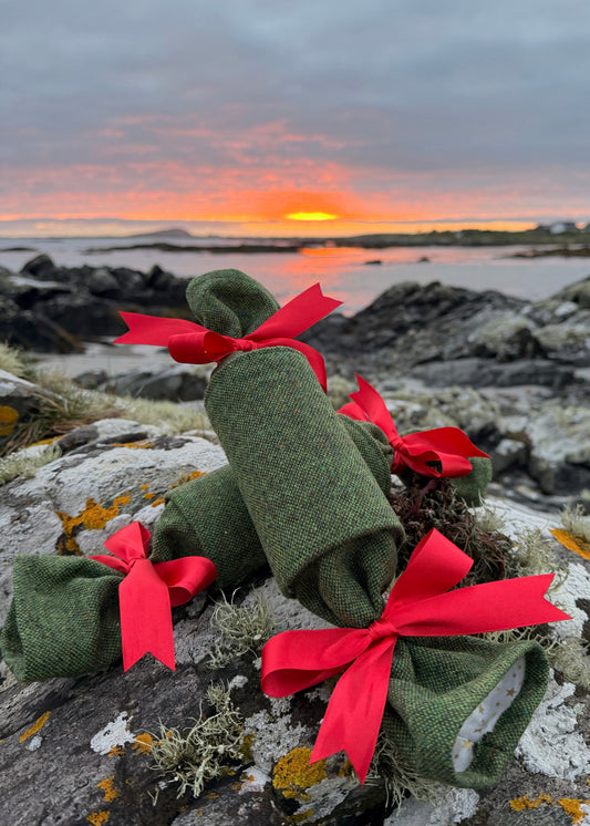 Handcrafted in Ireland, our Yuletide Tweed Christmas Crackers combine the heritage of Irish weaving with the timeless tradition of the Christmas cracker.

Design & Materials

Each cracker is made using authentic Magee Donegal Tweed in Eske – Green Salt & Pepper Flecked Donegal Tweed. The rich green tones and subtle flecking are inspired by the Irish landscape, while luxurious satin ribbon bows add an elegant festive finish.

Reusable, Refillable & Sustainable


