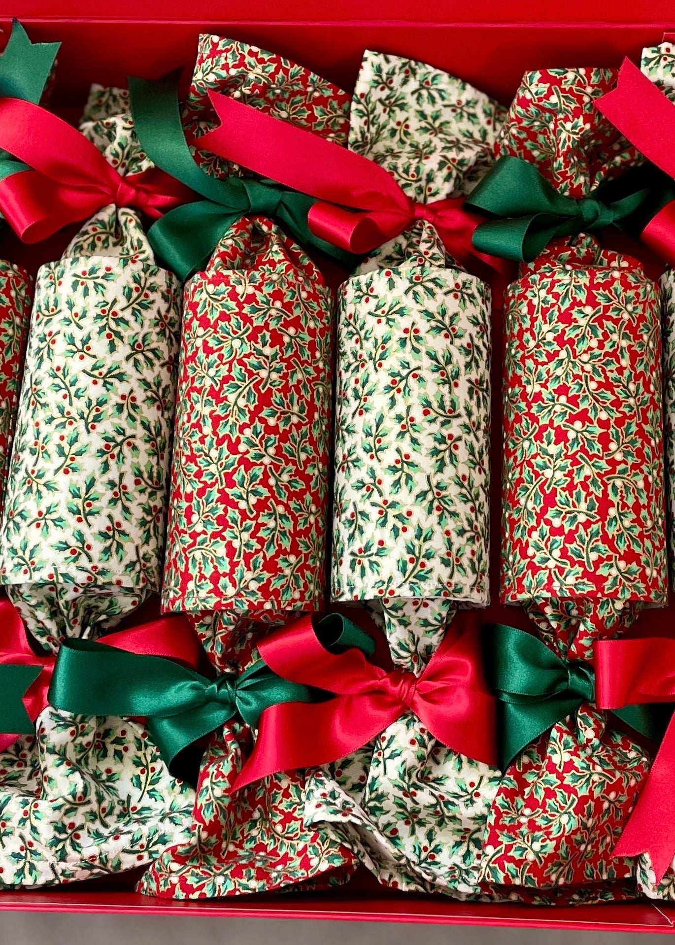 Fabric christmas crackers in holly design in red and white